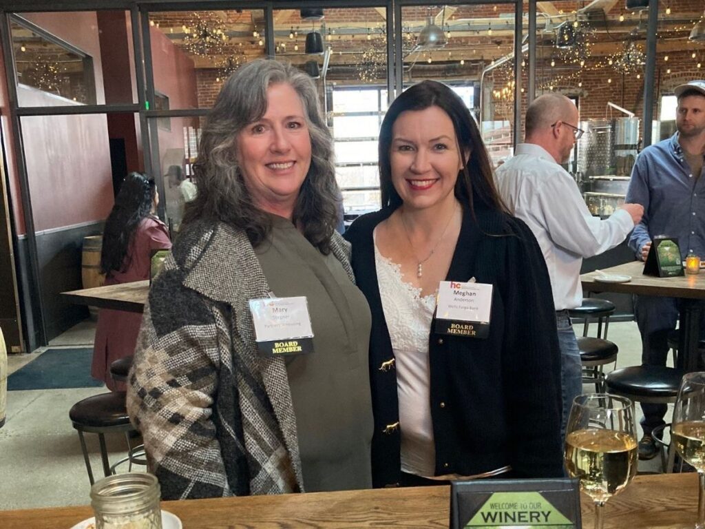 Two female, Housing Colorado board members pose together at a Winery